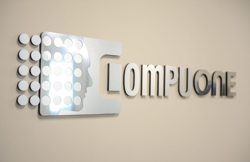 CompuOne logo sign on the wall.
