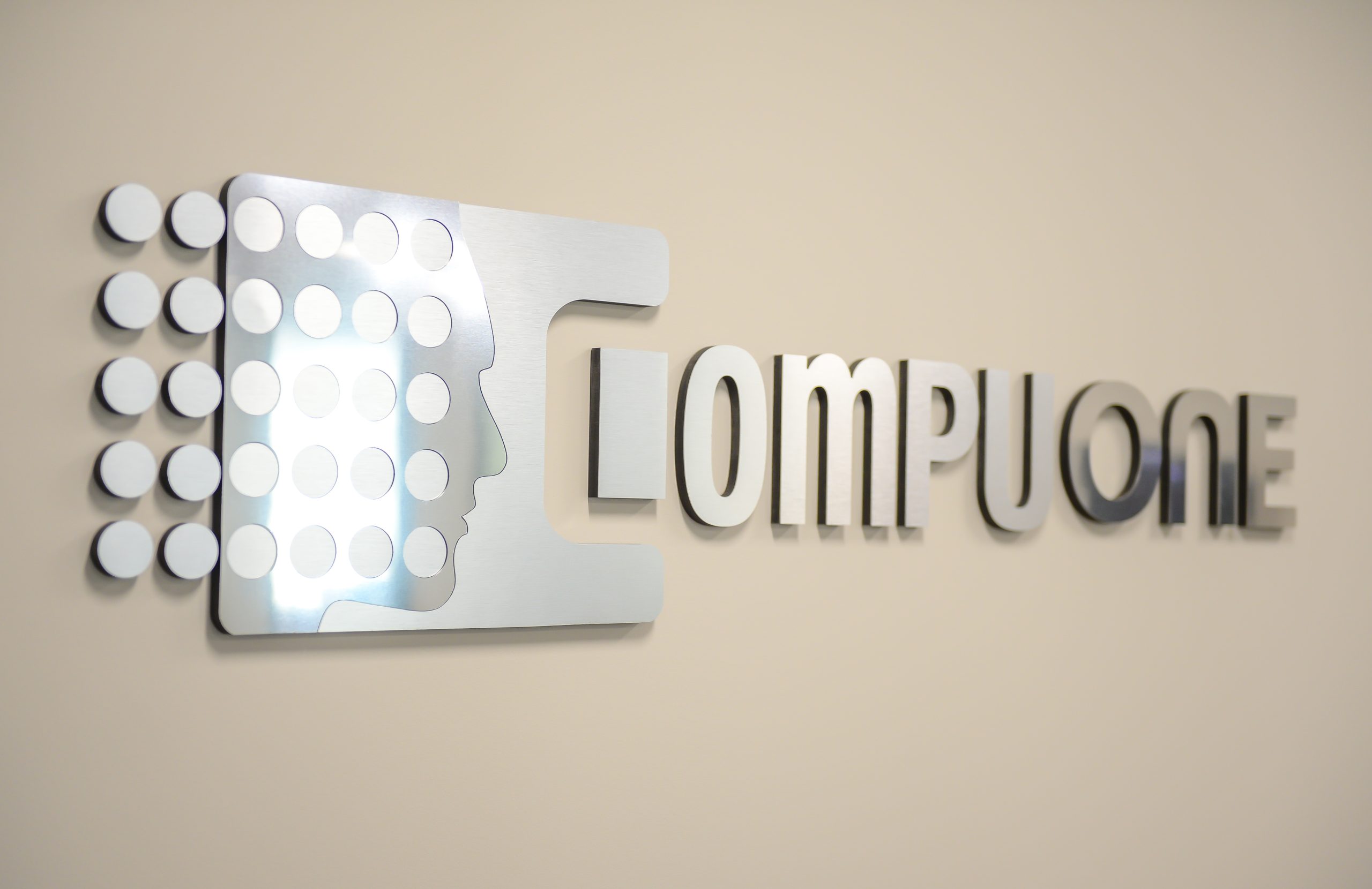 CompuOne logo sign on the wall.
