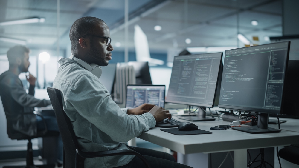 Man working at a computer.
